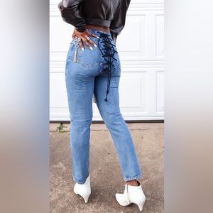 Denim jeans with black and white lace string in the back